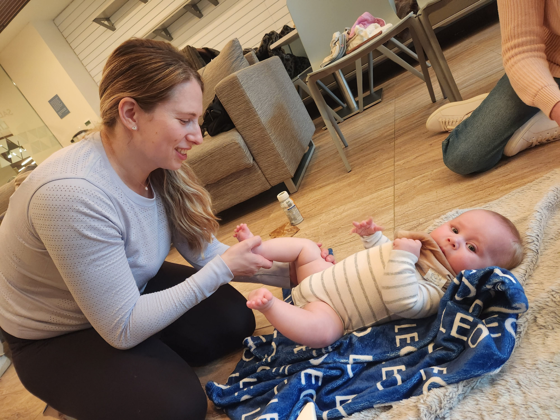 Mother massaging her baby's legs