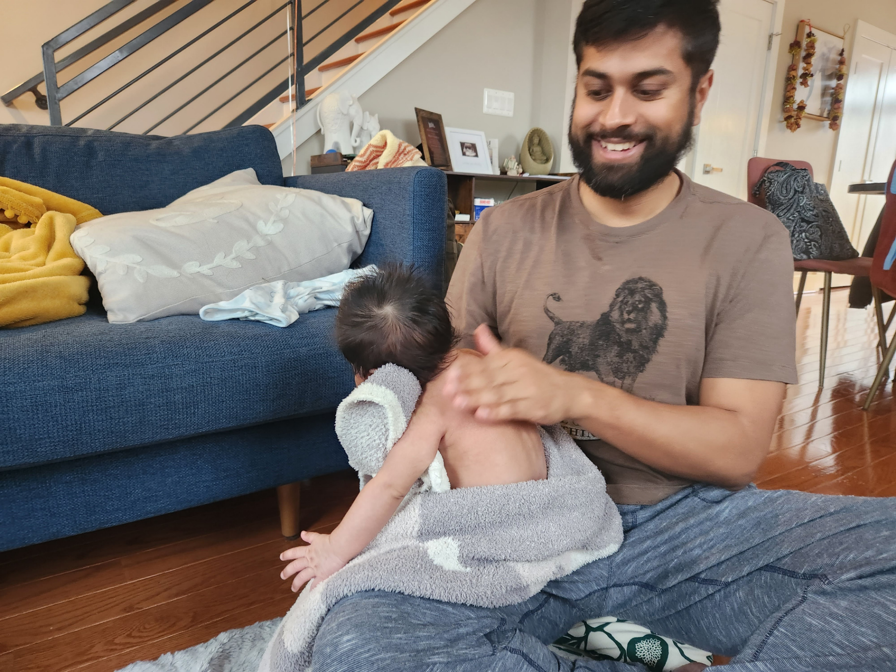 Father learning to massage his baby
