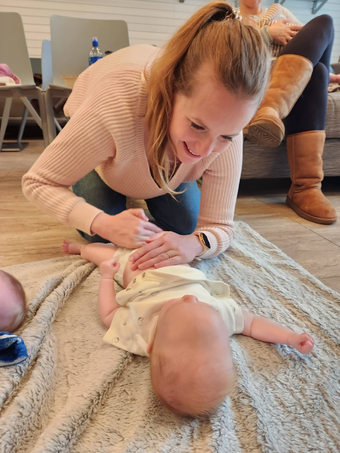 Mother playing with baby during class
